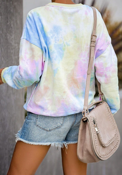 Back view of model wearing pink and blue tie-dye drop shoulder pullover sweater