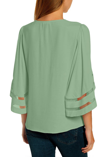 Back view of model wearing sage green 3-4 bell mesh panel sleeves strappy V-neckline loose top.
