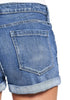 Close up shot of light blue roll-over hem button-up distressed denim shorts
