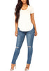Front full body shot of model wearing medium blue drawstring-waist washout ripped skinny jeans