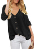 Front view of model wearing black V-neckline 34 cuffed sleeves button-up loose top.