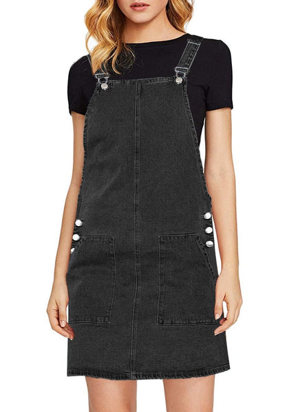 Front view of model wearing black side pockets overall denim pinafore dress