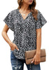 Front view of model wearing black tie-up neckline flared short sleeves printed top