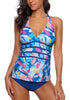 Front view of model wearing blue abstract-print halter tankini set