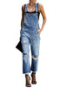 Front view of model wearing blue cropped raw hem ripped denim bib overall