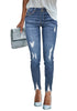 Front view of model wearing blue double button ripped skinny denim jeans