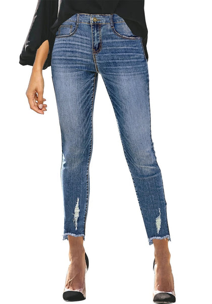 Front view of model wearing blue mid-waist raw hem  cropped ripped denim jeans
