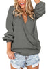 Front view of model wearing dark grey lantern sleeves surplice sweater