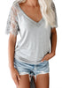 Front view of model wearing grey crochet lace short sleeves V-neckline top