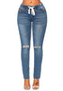 Front view of model wearing medium blue drawstring-waist washout ripped skinny jeans