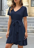 Front view of model wearing navy V-neckline short sleeves belted ruffle dress