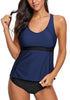Front view of model wearing navy blue racerback tankini set