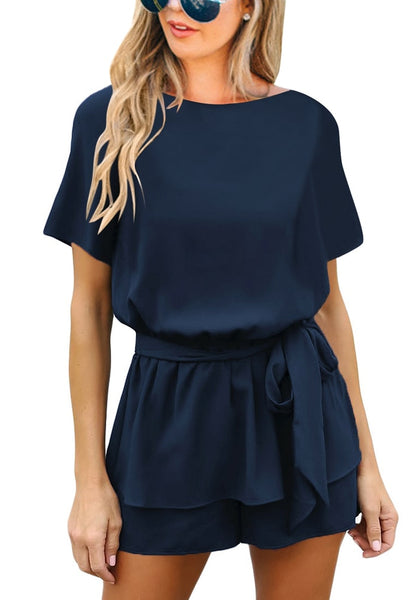 Front view of model wearing navy short sleeves keyhole-back belted romper