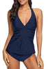 Front view of model wearing navy solid color halter tankini set