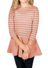Front view of model wearing pink striped ruffle hem flared girl tunic top