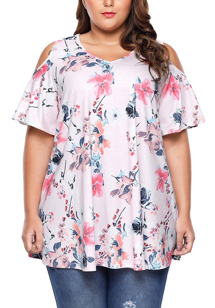 Front view of model wearing plus size light pink floral cold-shoulder blouse