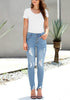 Front view of sexy model wearing light blue high-rise ripped denim buttoned denim jeans