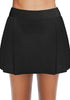 Front view of model wearing black pleated side mid-waist swim skirt