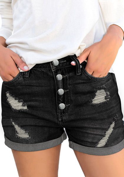 Front view of model wearing black roll-over hem button-up ripped denim shorts