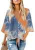Front view of model wearing blue tie-dye V-neckline button-up tie-front top