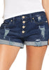 Front view of model wearing dark blue roll-over hem button-up distressed denim shorts