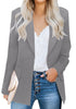 Front view of model wearing grey lapel front-button side-pockets blazer