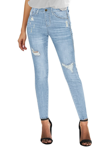 Front view of model wearing light blue high-rise ripped skinny denim jeans