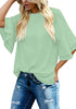 Front view of model wearing mint green trumpet sleeves keyhole-back blouse