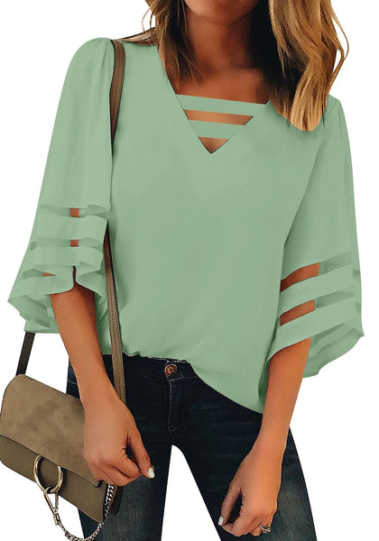 Front view of model wearing sage green 3-4 bell mesh panel sleeves strappy V-neckline loose top.