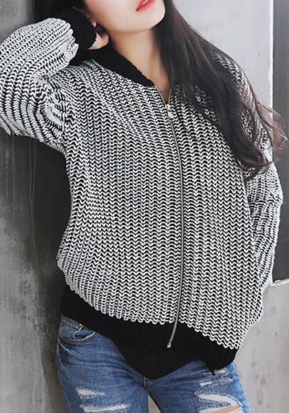 Girl in a zipped black and white knitted baseball jacket
