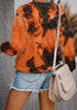 Back view of model wearing orange tie-dye crewneck drop shoulder pullover sweater