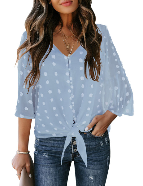 Front view of model wearing light blue swiss dot 3/4 sleeves tie-front button down top