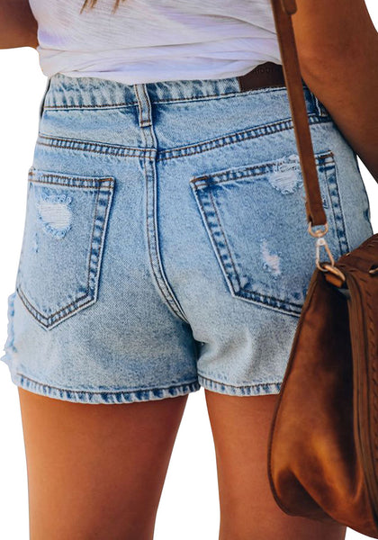 Back view of model wearing light blue mid-waist distressed washed denim shorts
