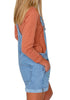 Side view of model wearing light blue floral embroidery rolled hem shorts bib overall