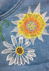 Close up view of light blue floral embroidery rolled hem shorts bib overall