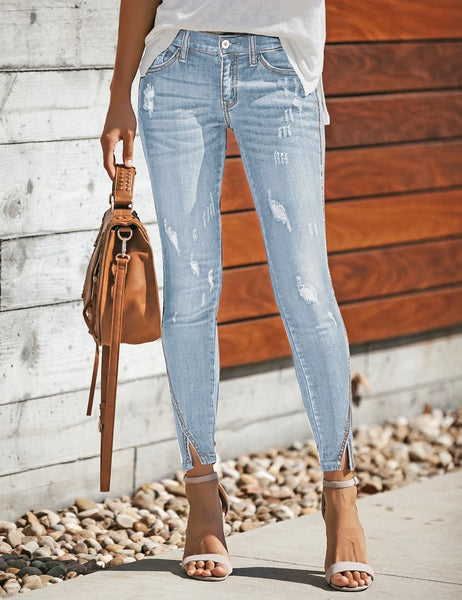 Front view of model wearing light blue split-hem ripped skinny denim jeans