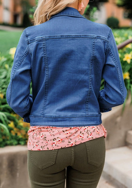 Back view of model wearing deep blue button down women's denim jacket