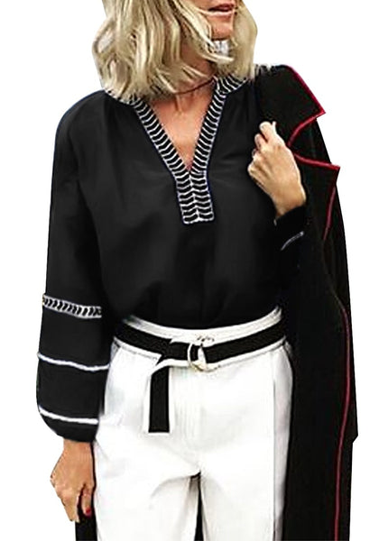 Model poses wearing black notched V-neckline lantern sleeves boho top