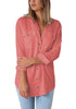 Model poses wearing coral long cuffed sleeves lapel button-up blouse