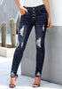 Model poses wearing dark blue high-rise ripped buttoned denim jeans