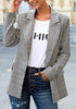 Model poses wearing grey plaid lapel front-button side-pockets blazer