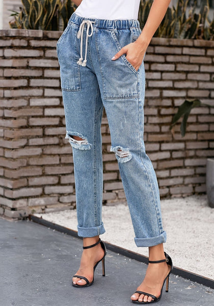 Model poses wearing light blue drawstring-waist cuffed ripped boyfriend jeans
