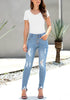 Model poses wearing light blue high-rise ripped denim buttoned denim jeans