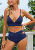 Model poses wearing navy crisscross-waist cutout ruched bikini bottom