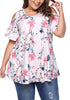 Model poses wearing plus size light pink floral cold-shoulder blouse