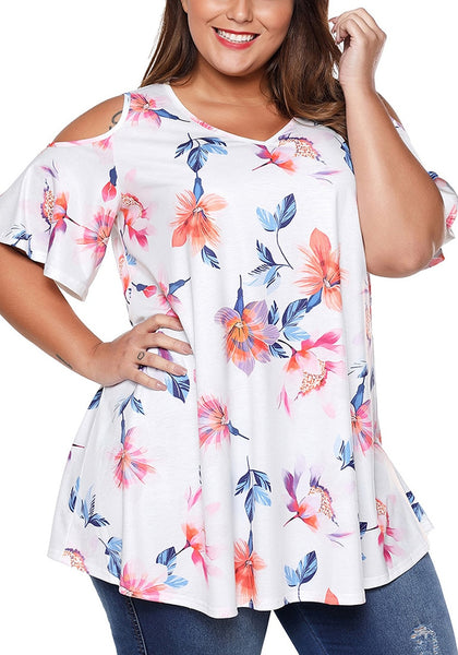 Model poses wearing plus size white floral cold-shoulder blouse