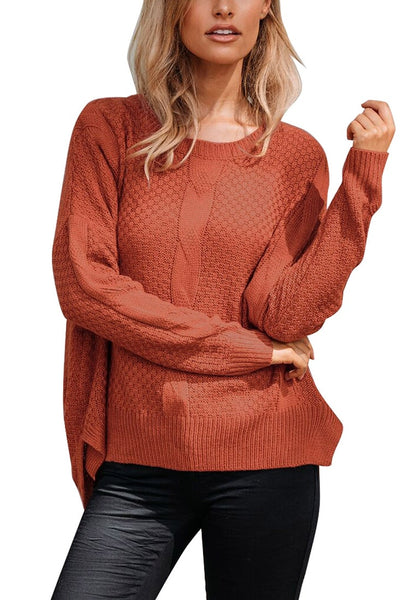 Model poses wearing rust red ribbed knit textured side-slit sweater