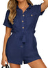 Model poses wearing white navy blue sleeves button-down belted romper
