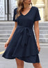 Model wearing navy V-neckline short sleeves belted ruffle dress