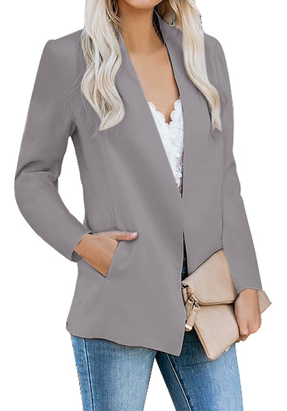 Model poses wearing grey open-front side pockets blazer